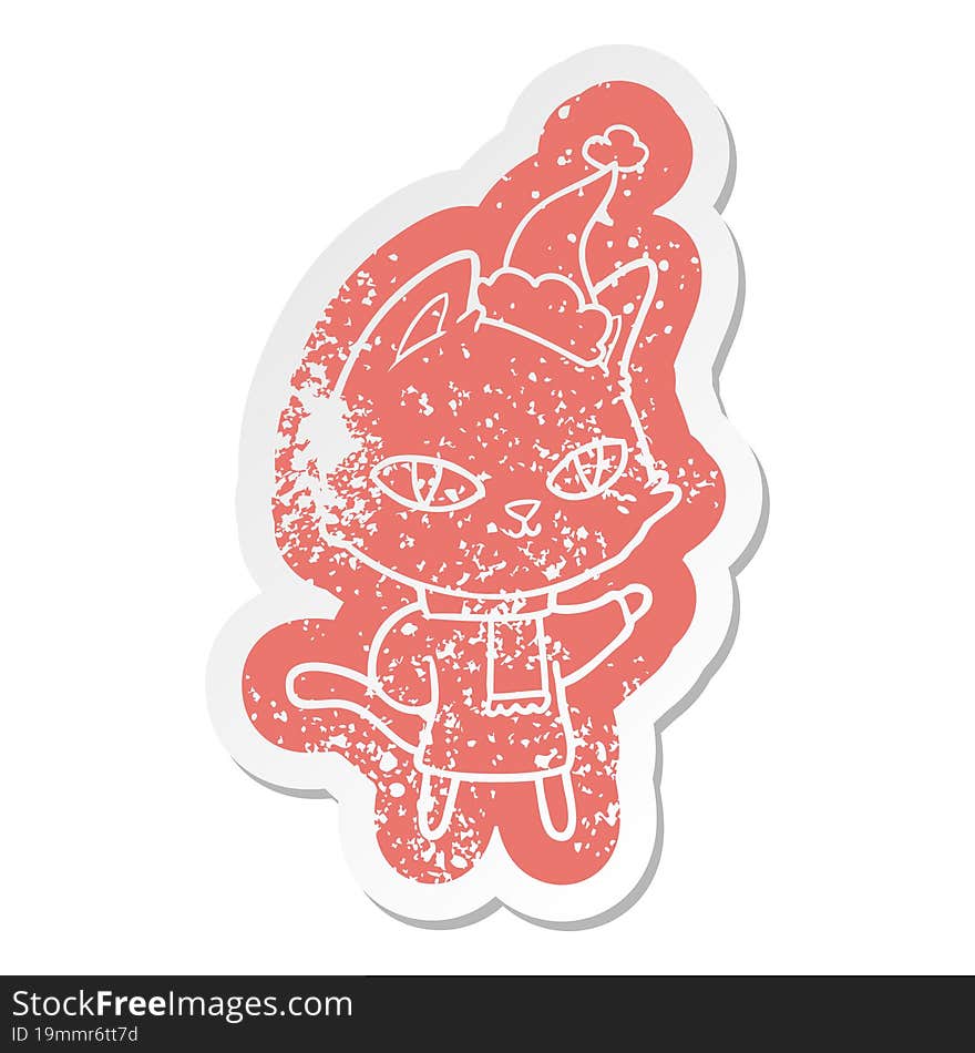 cartoon distressed sticker of a cat staring wearing santa hat