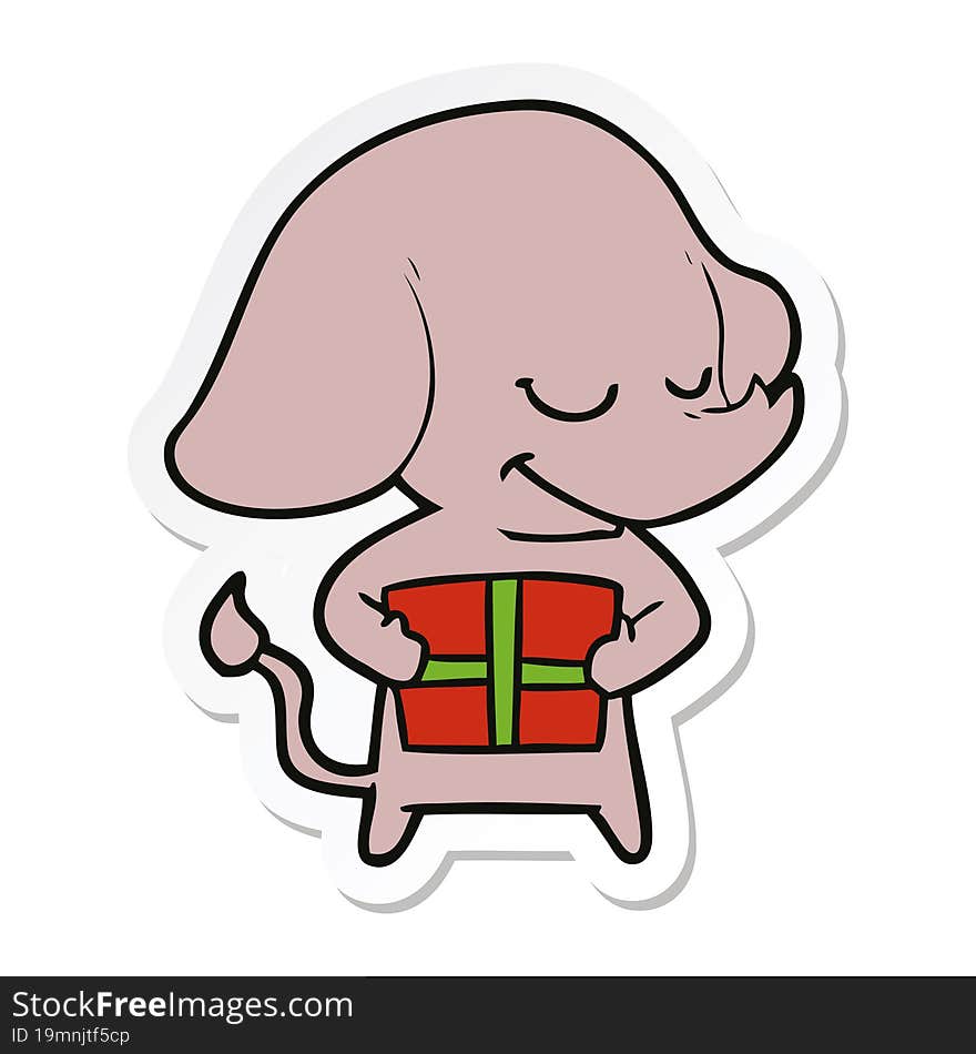 sticker of a cartoon smiling elephant with present