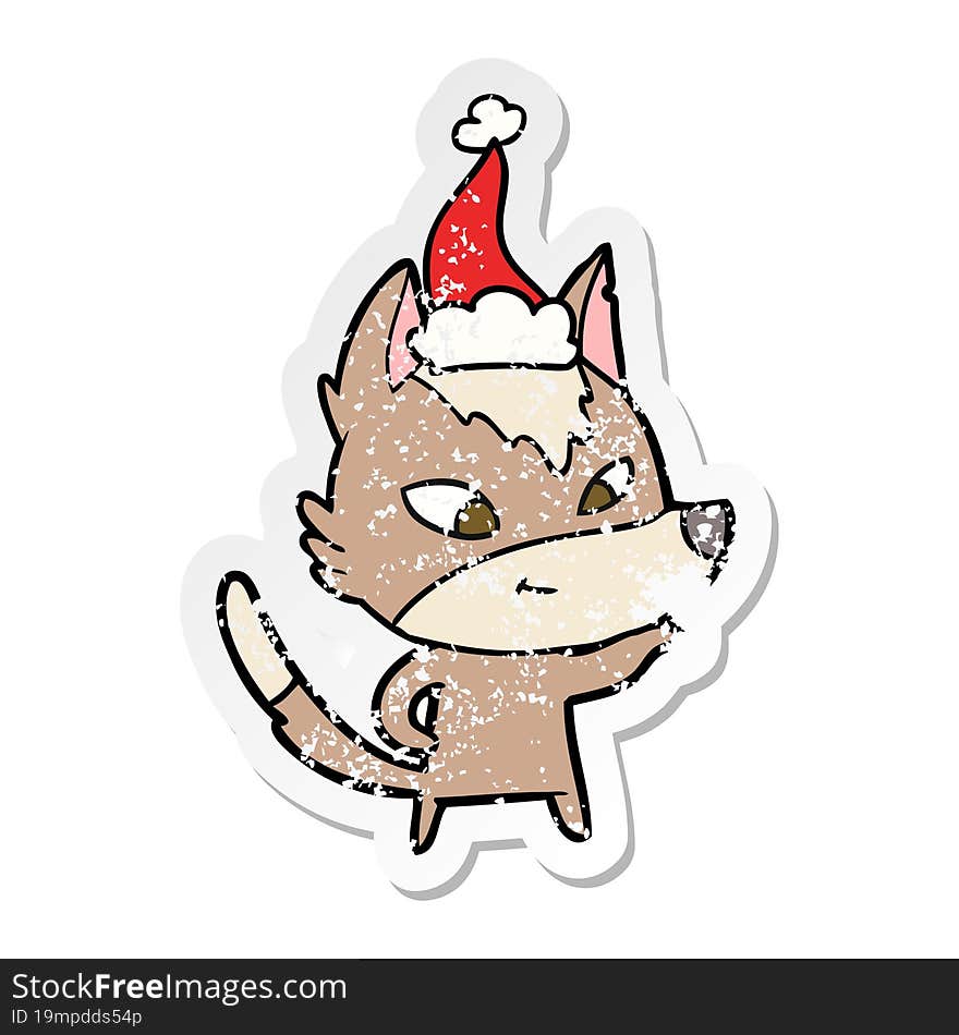 friendly distressed sticker cartoon of a wolf wearing santa hat