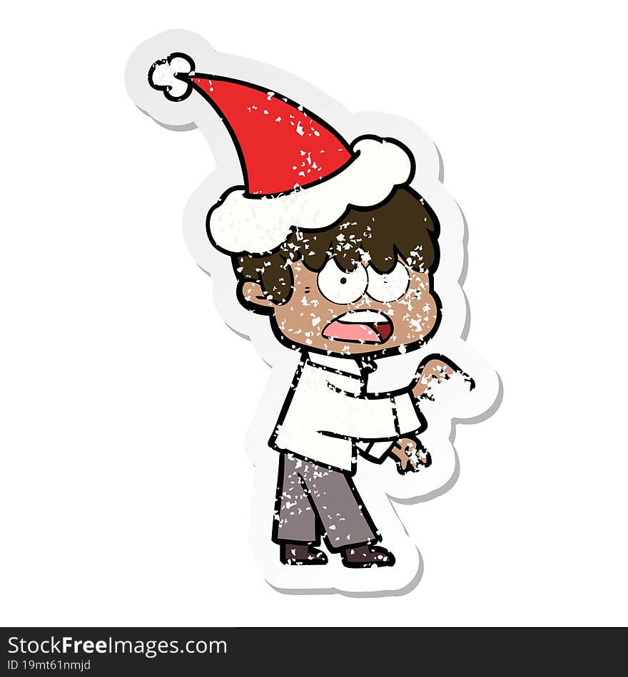 worried distressed sticker cartoon of a boy wearing santa hat