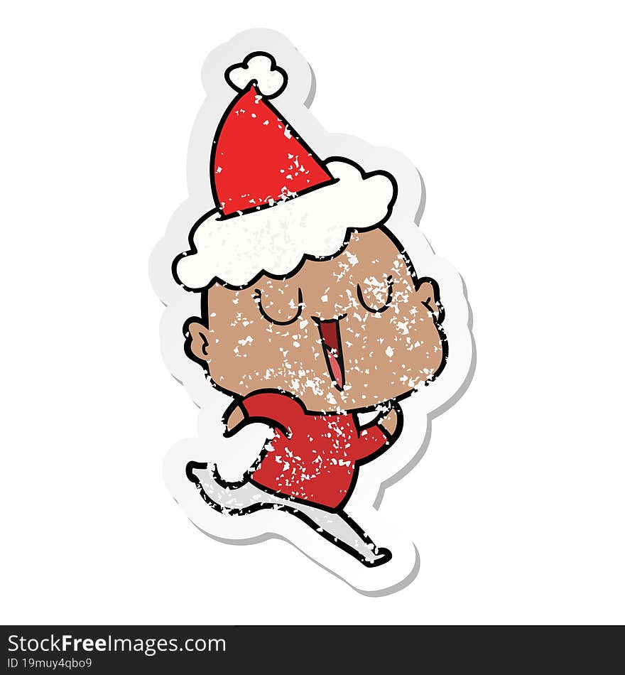 happy distressed sticker cartoon of a bald man wearing santa hat