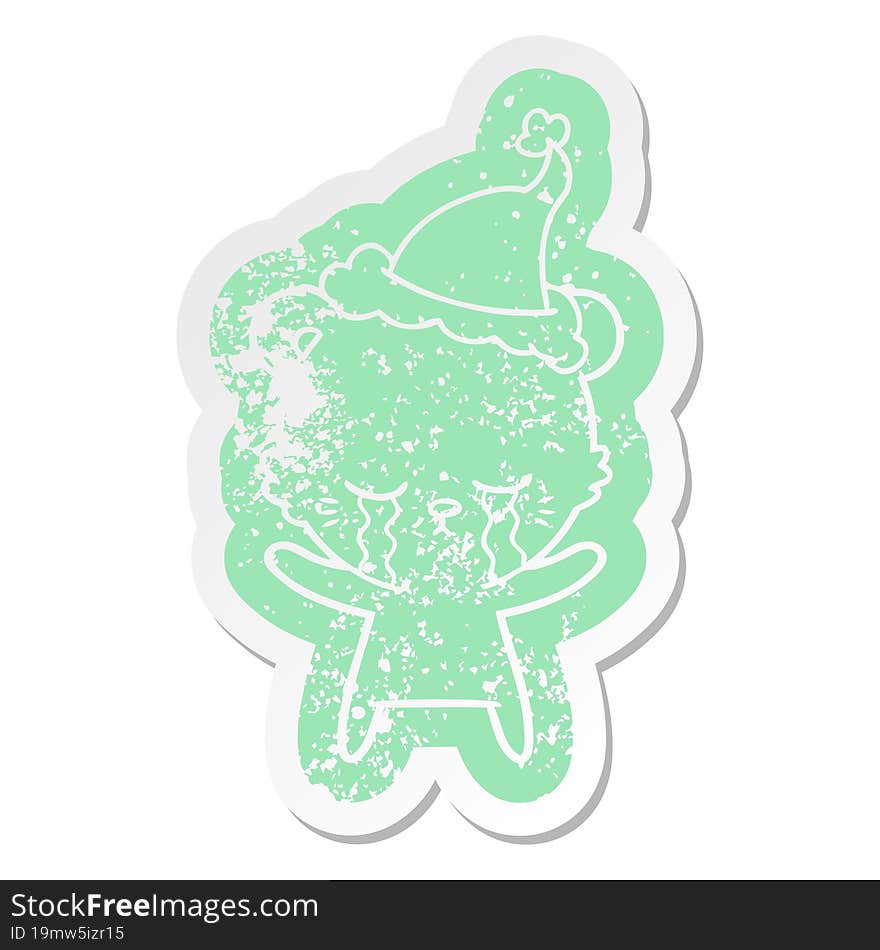 crying cartoon distressed sticker of a polarbear wearing santa hat