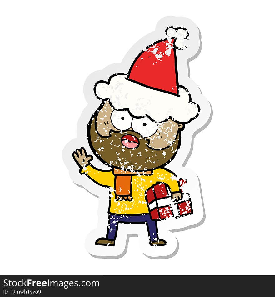 distressed sticker cartoon of a bearded man with present wearing santa hat