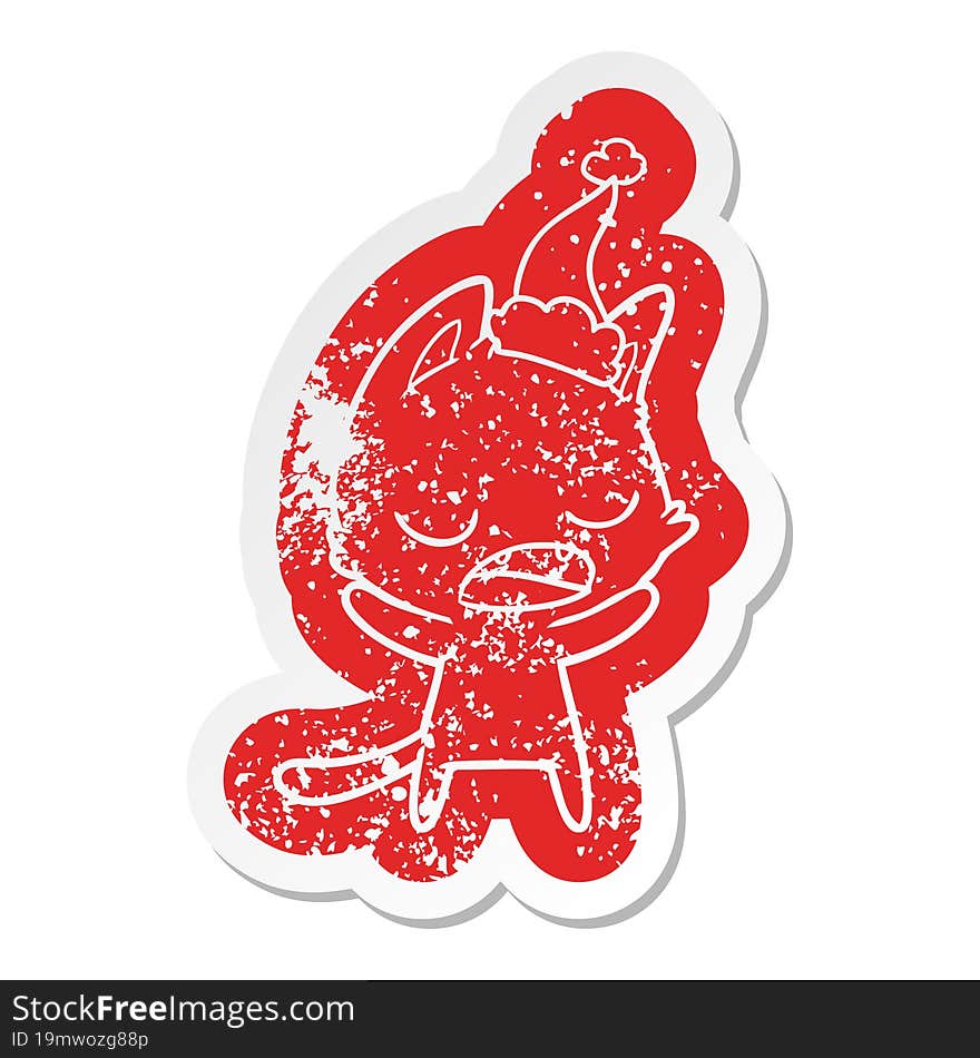 talking cat cartoon distressed sticker of a wearing santa hat