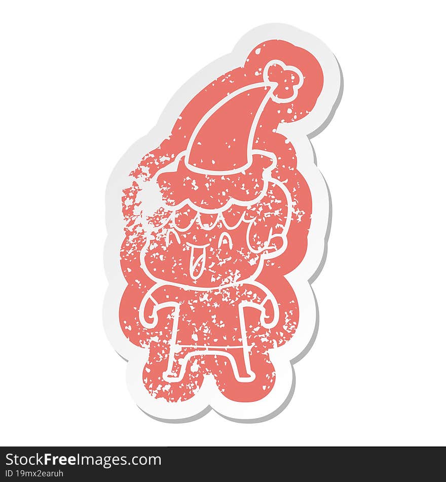 quirky cartoon distressed sticker of a laughing boy wearing santa hat