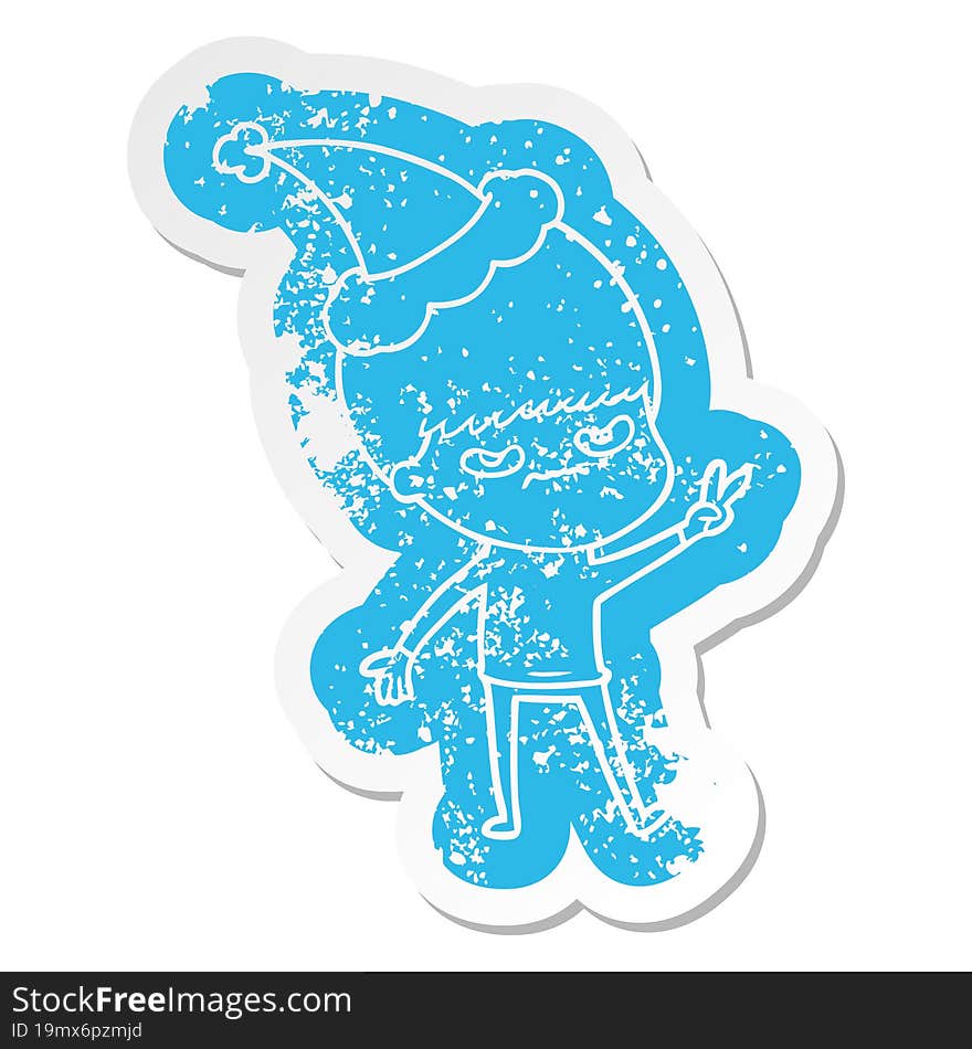 annoyed cartoon distressed sticker of a boy wearing santa hat