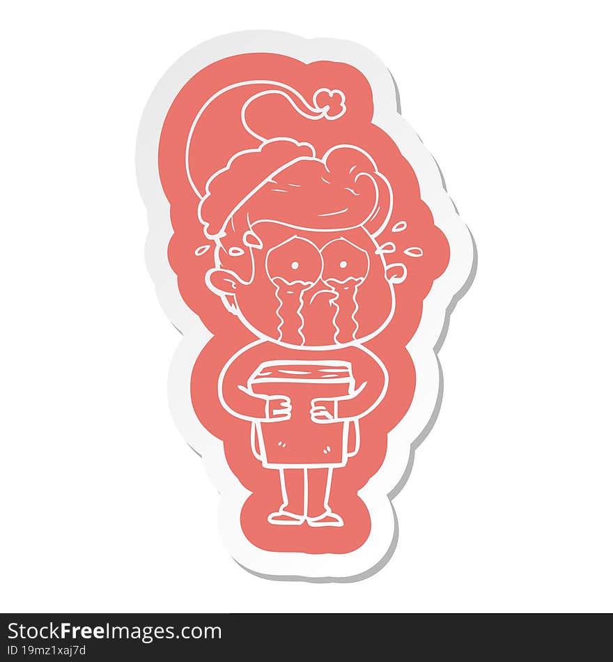 cartoon  sticker of a crying man holding book wearing santa hat