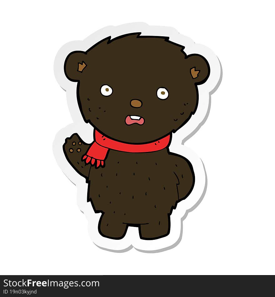 sticker of a cartoon black bear wearing scarf