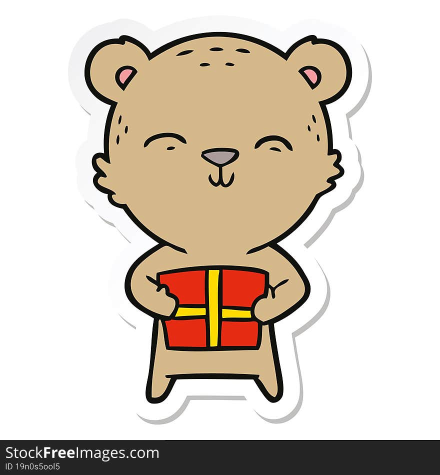 sticker of a happy cartoon bear with gift