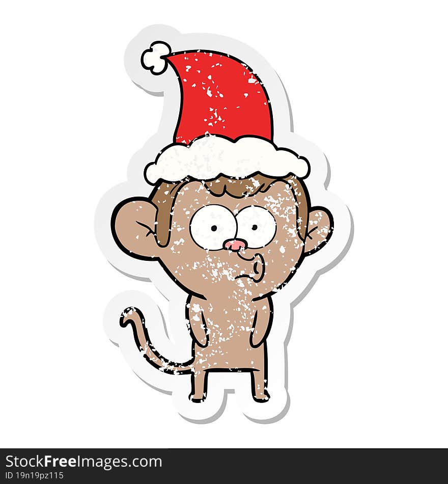 distressed sticker cartoon of a hooting monkey wearing santa hat