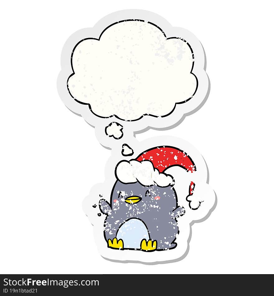 cartoon penguin wearing christmas hat and thought bubble as a distressed worn sticker