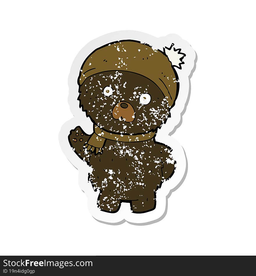 retro distressed sticker of a cartoon cute black bear in winter hat and scarf