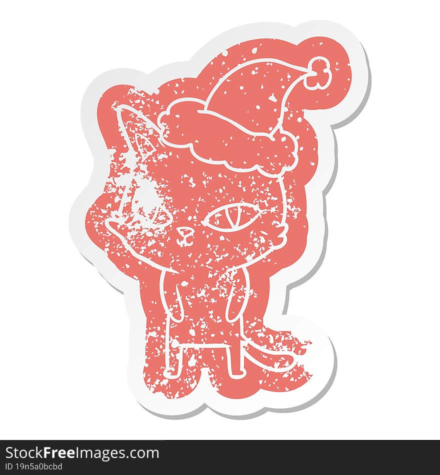 cartoon distressed sticker of a cat with bright eyes wearing santa hat