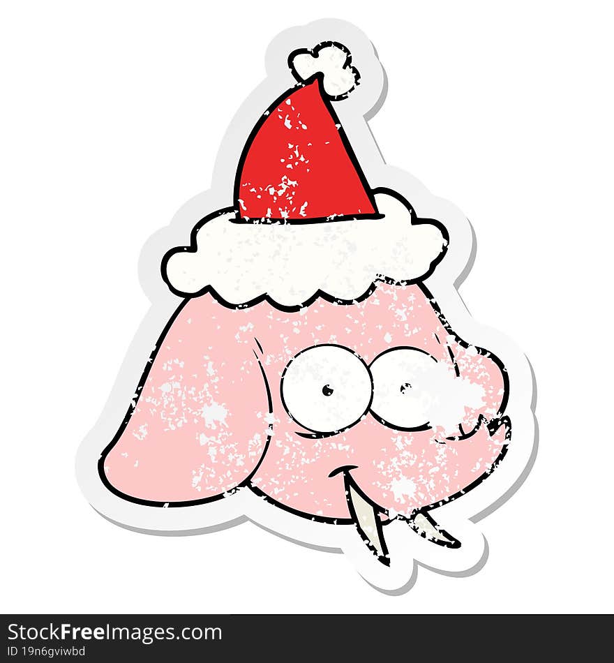 distressed sticker cartoon of a elephant face wearing santa hat