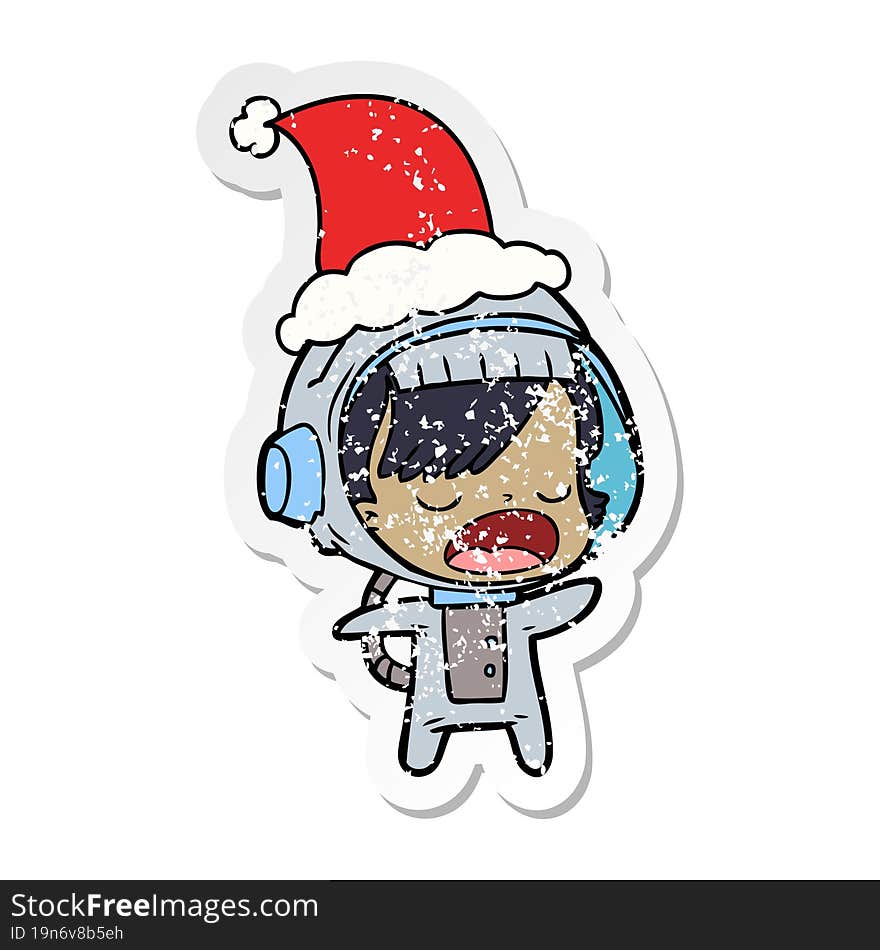 distressed sticker cartoon of a talking astronaut woman wearing santa hat