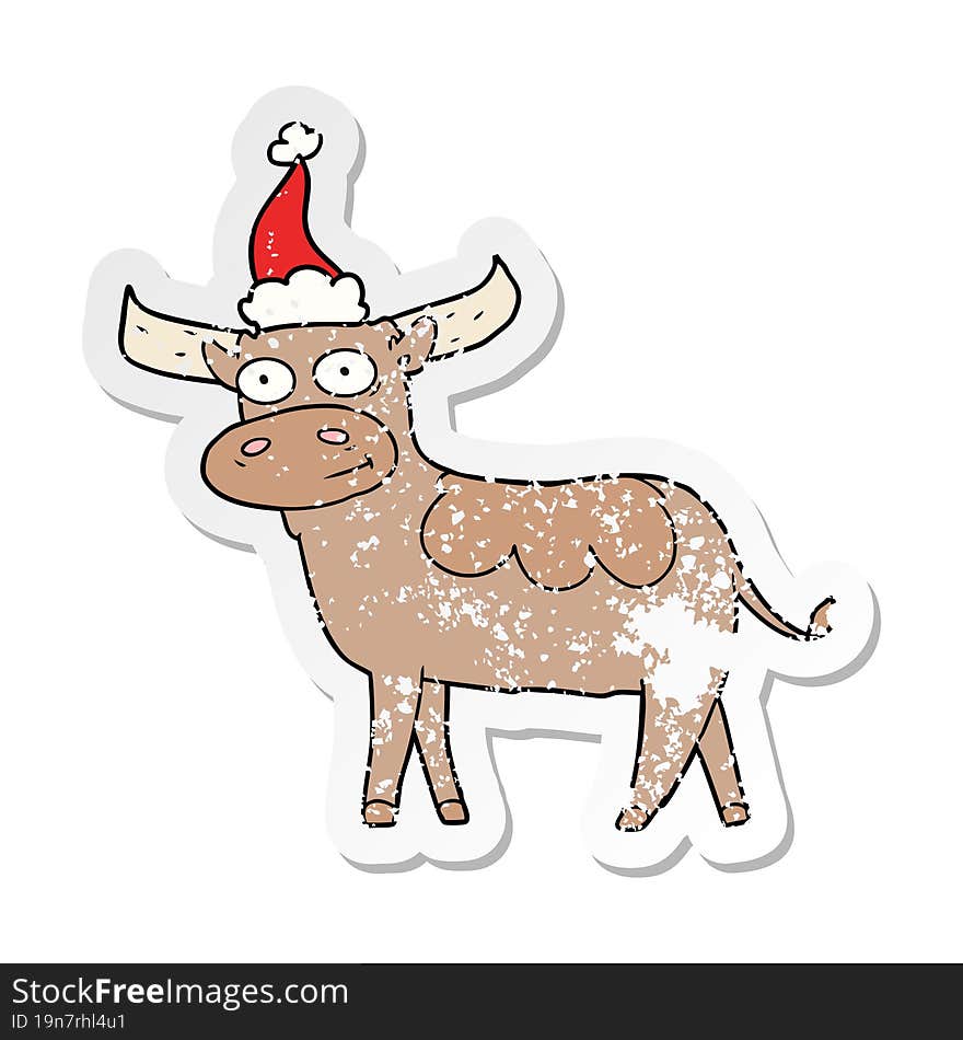 Distressed Sticker Cartoon Of A Bull Wearing Santa Hat