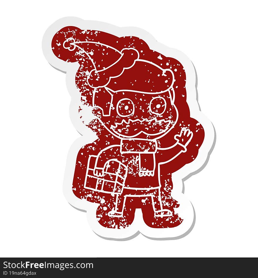 cartoon distressed sticker of a man with mustache and christmas present wearing santa hat