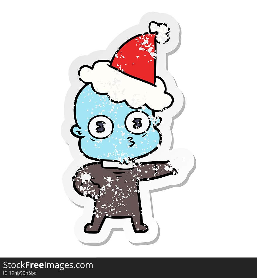 Distressed Sticker Cartoon Of A Weird Bald Spaceman Wearing Santa Hat