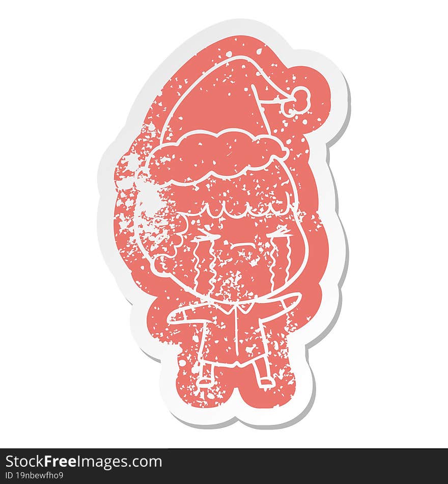 cartoon distressed sticker of a man crying wearing santa hat