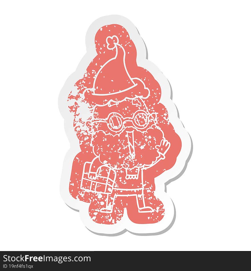 cartoon distressed sticker of a joyful man with beard and parcel under arm wearing santa hat