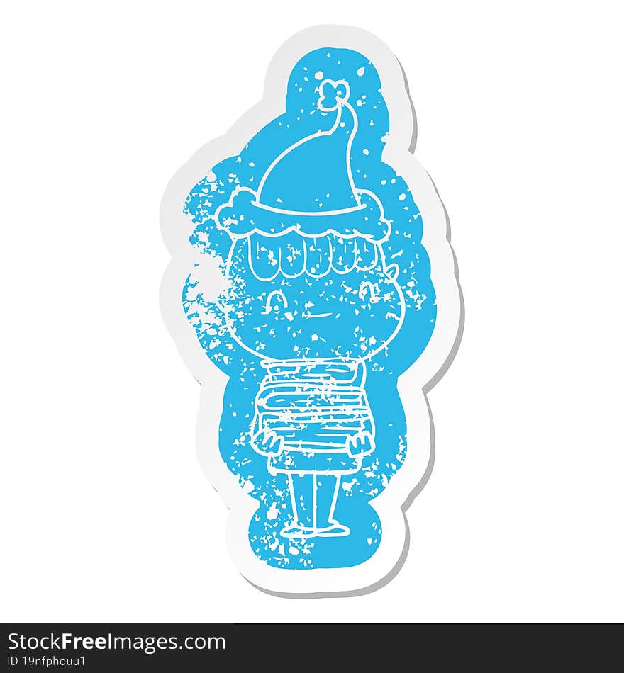 Cartoon Distressed Sticker Of A Friendly Boy With Books Wearing Santa Hat