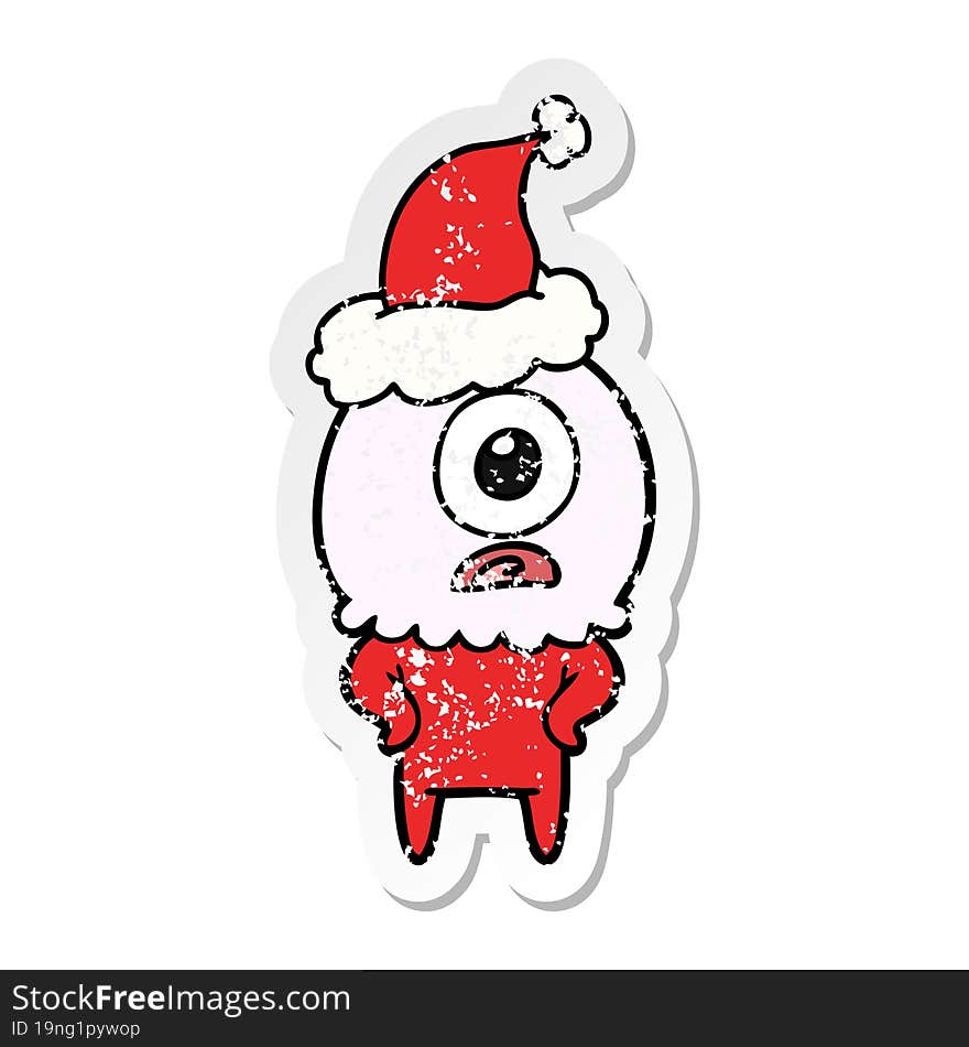 hand drawn distressed sticker cartoon of a cyclops alien spaceman wearing santa hat