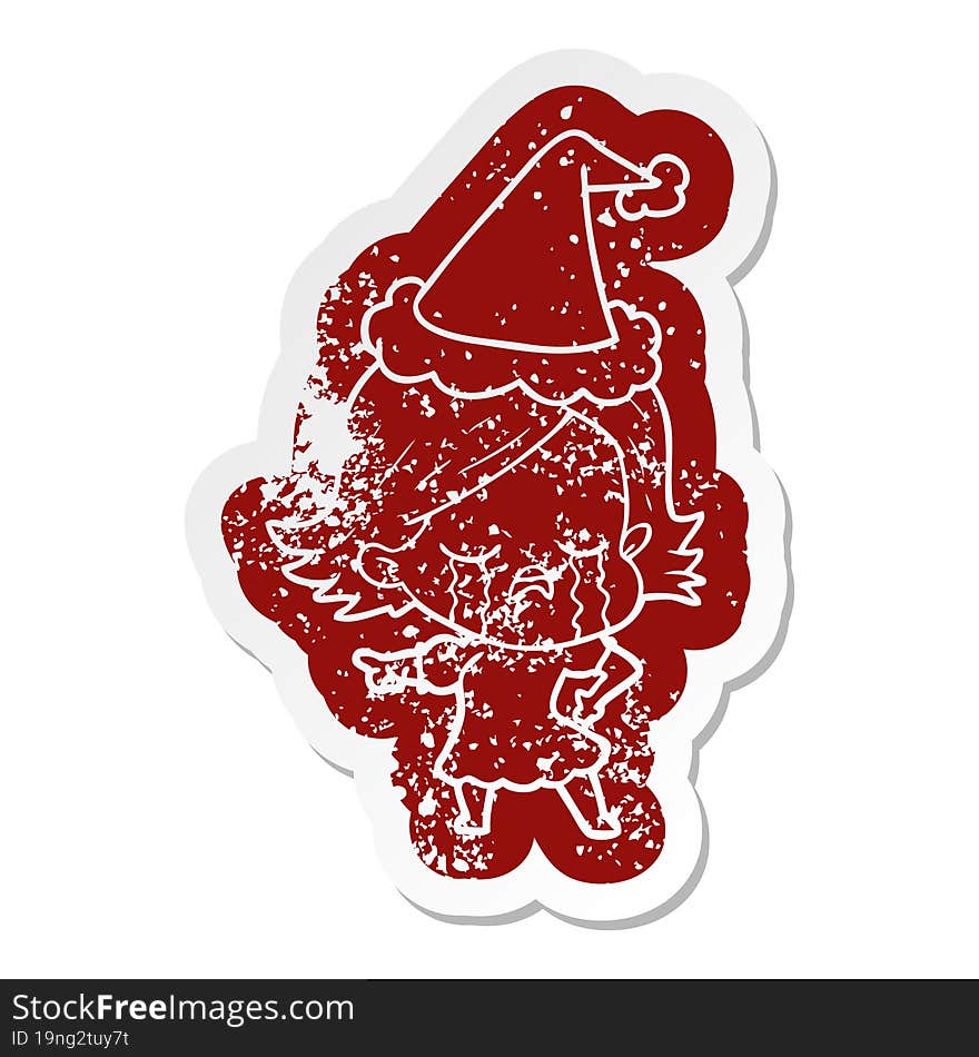 Cartoon Distressed Sticker Of A Girl Crying And Pointing Wearing Santa Hat