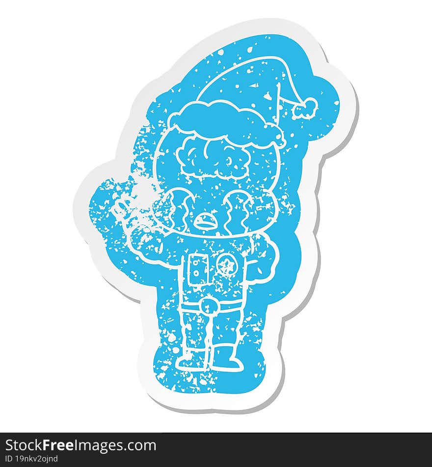 cartoon distressed sticker of a big brain alien crying wearing santa hat