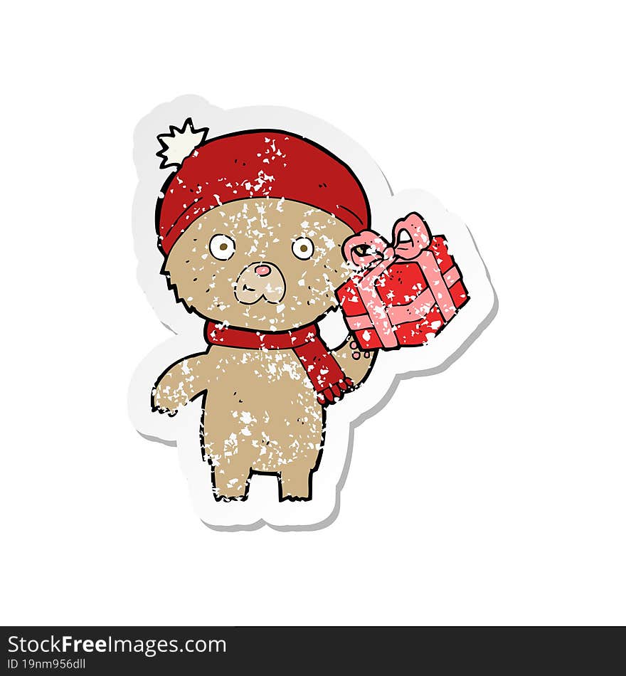 Retro Distressed Sticker Of A Cartoon Christmas Teddy Bear With Present