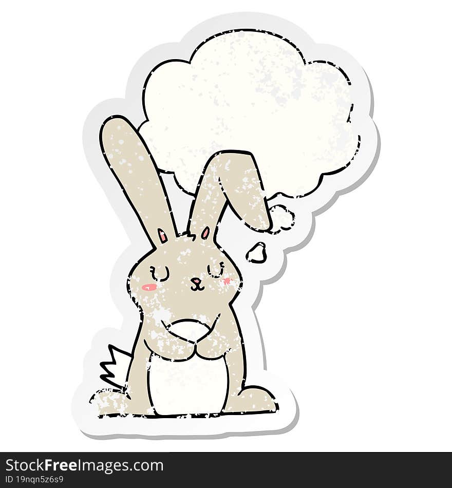 cartoon rabbit with thought bubble as a distressed worn sticker