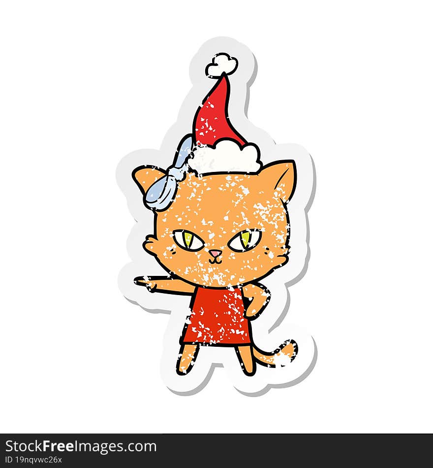 cute hand drawn distressed sticker cartoon of a cat wearing dress wearing santa hat