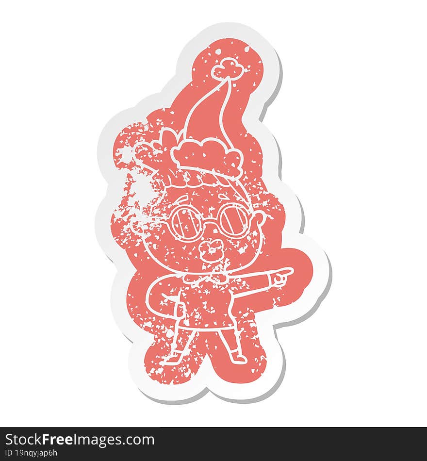 Cartoon Distressed Sticker Of A Pointing Woman Wearing Spectacles Wearing Santa Hat