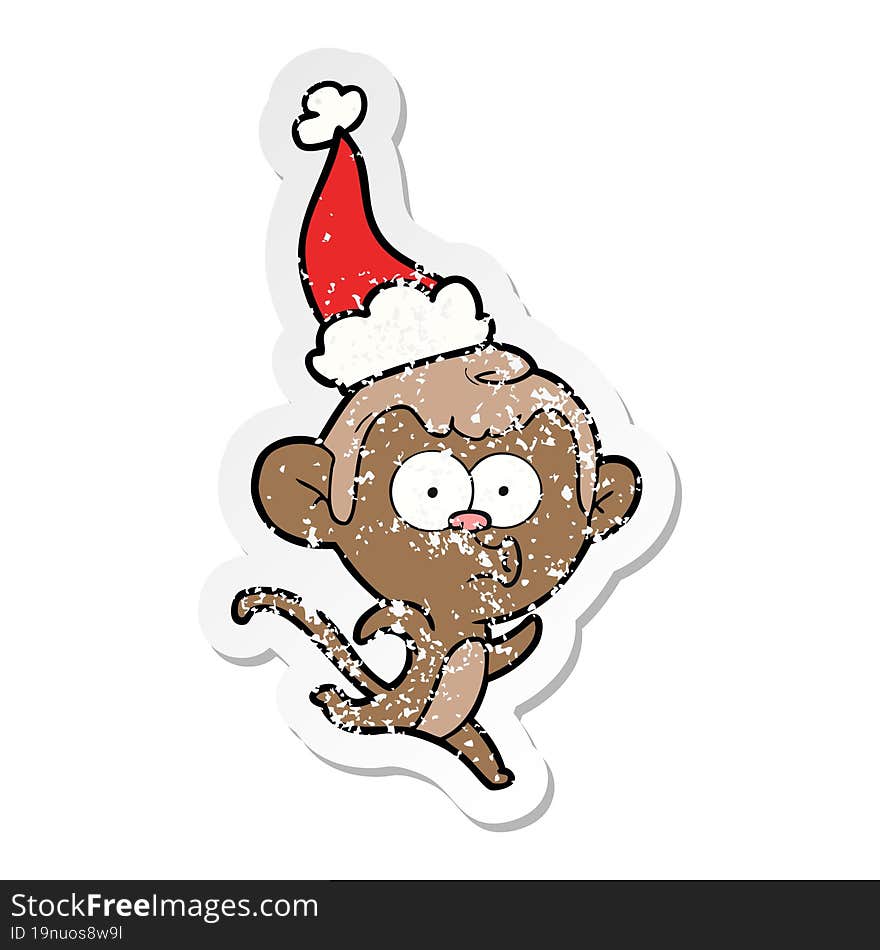 hand drawn distressed sticker cartoon of a surprised monkey wearing santa hat