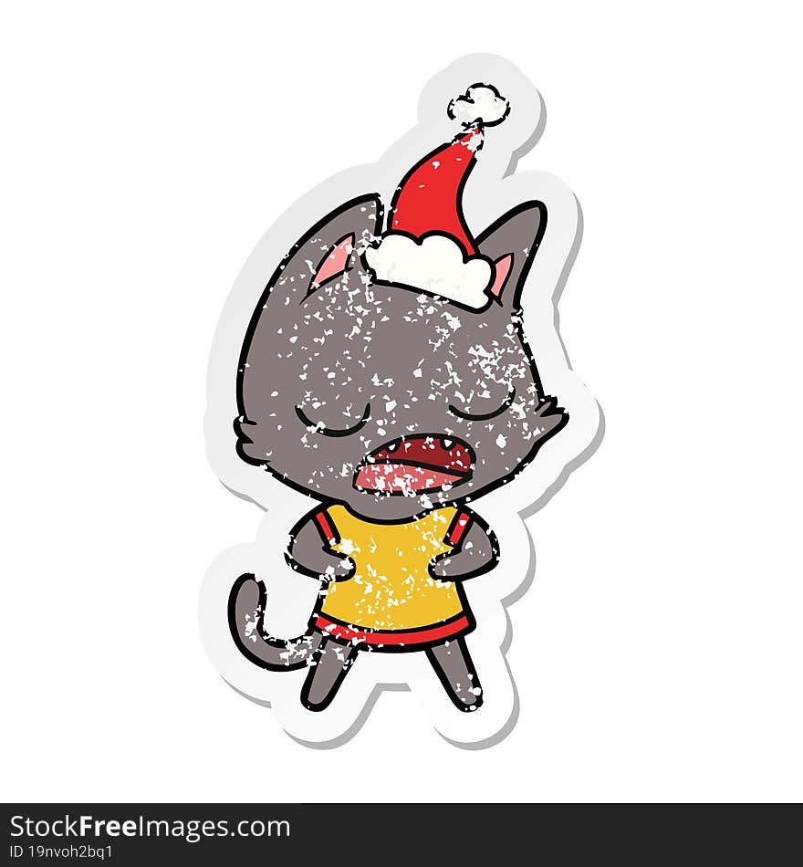 talking cat distressed sticker cartoon of a wearing santa hat