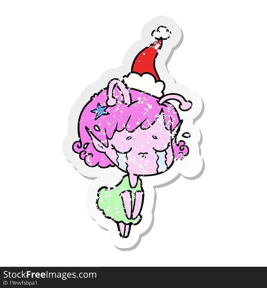 distressed sticker cartoon of a crying alien girl wearing santa hat