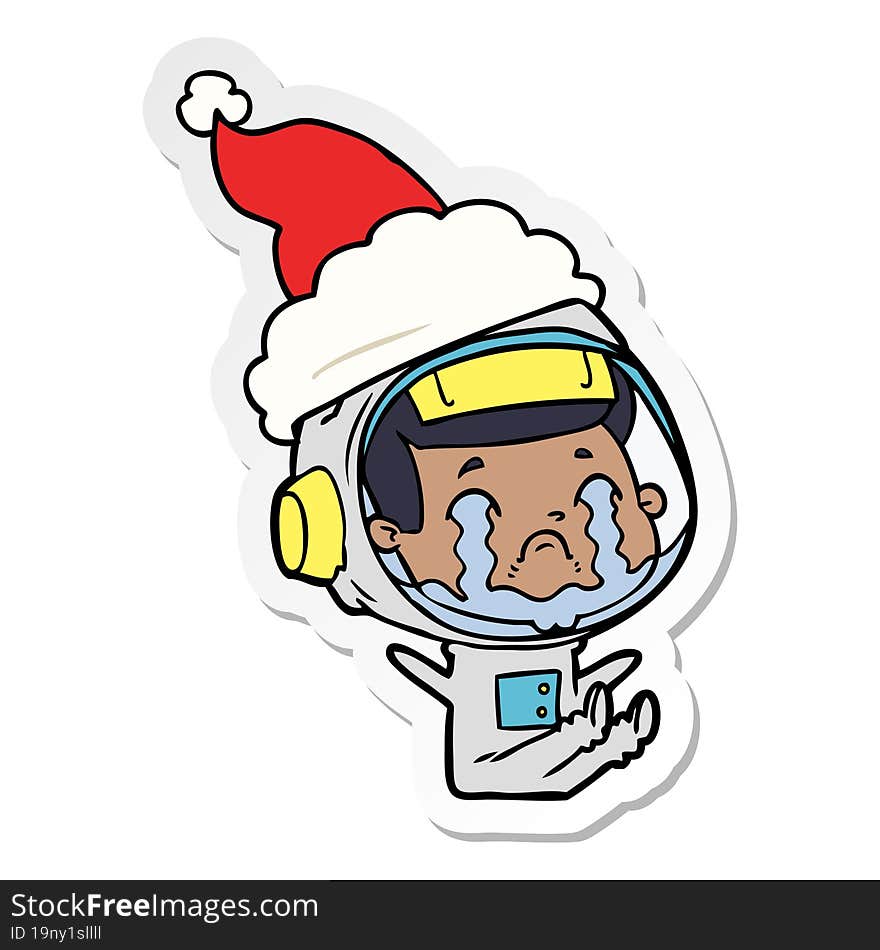 sticker cartoon of a crying astronaut wearing santa hat