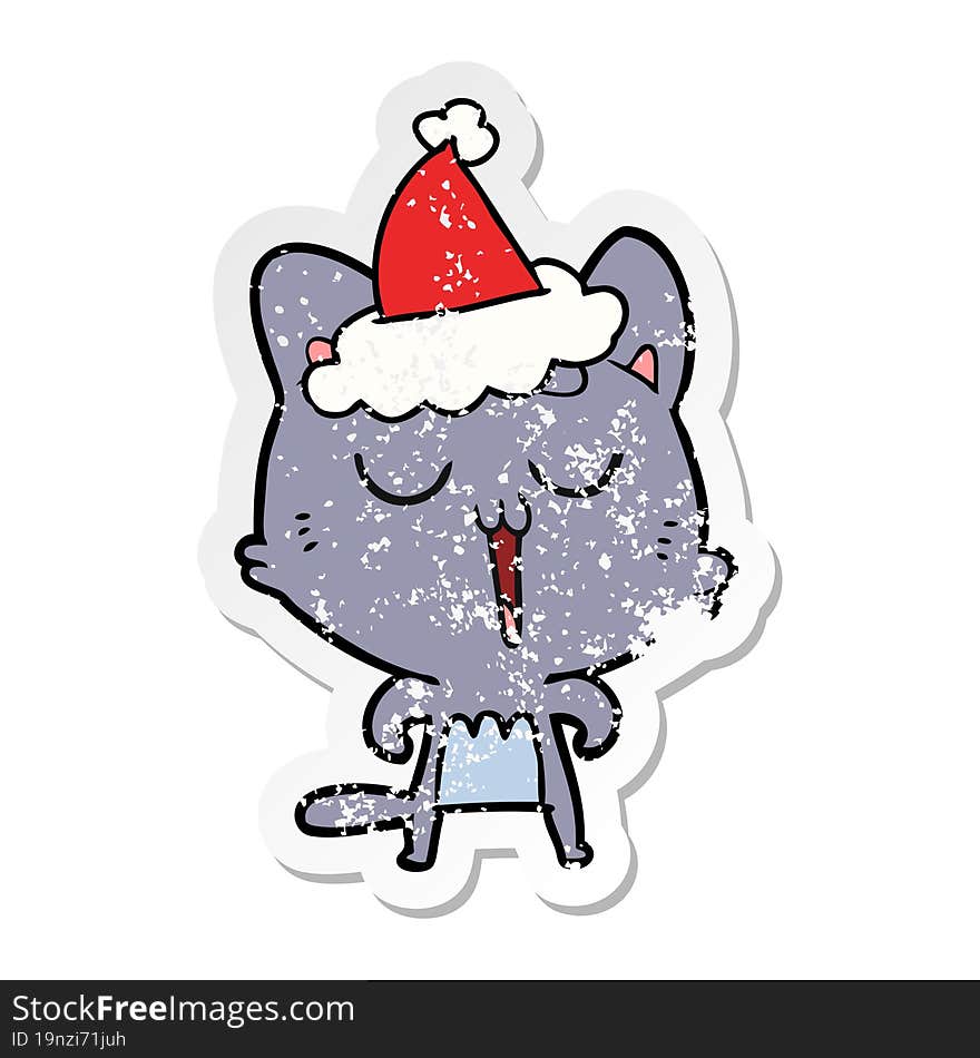 distressed sticker cartoon of a cat singing wearing santa hat