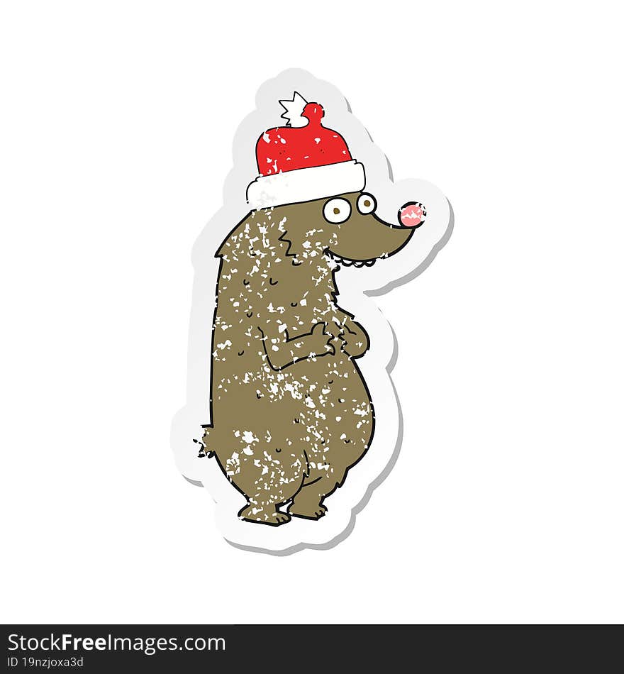 Retro Distressed Sticker Of A Cartoon Bear Wearing Christmas Hat