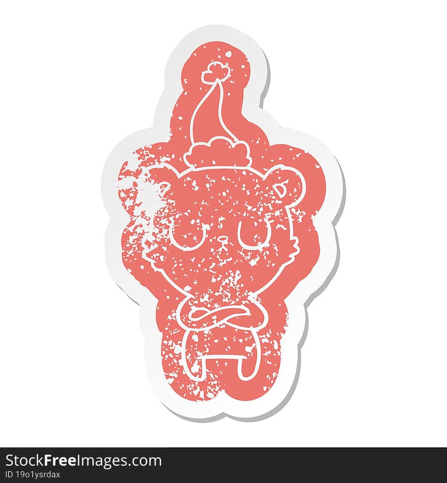 peaceful cartoon distressed sticker of a polar bear wearing santa hat