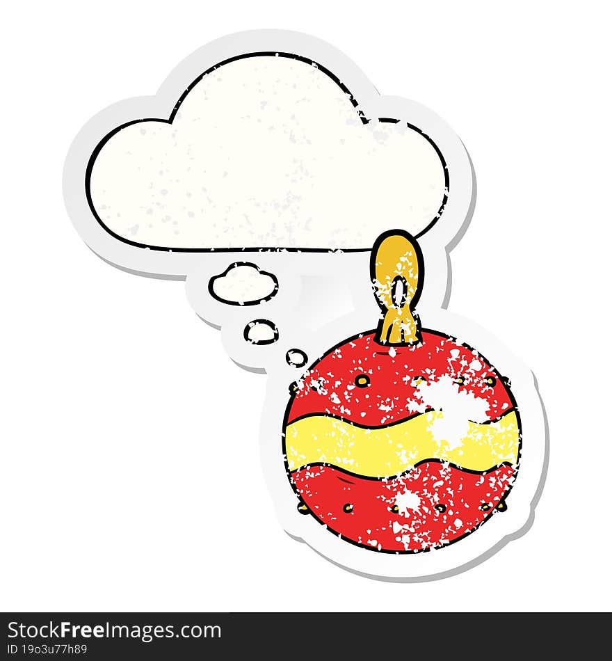 cartoon christmas bauble with thought bubble as a distressed worn sticker