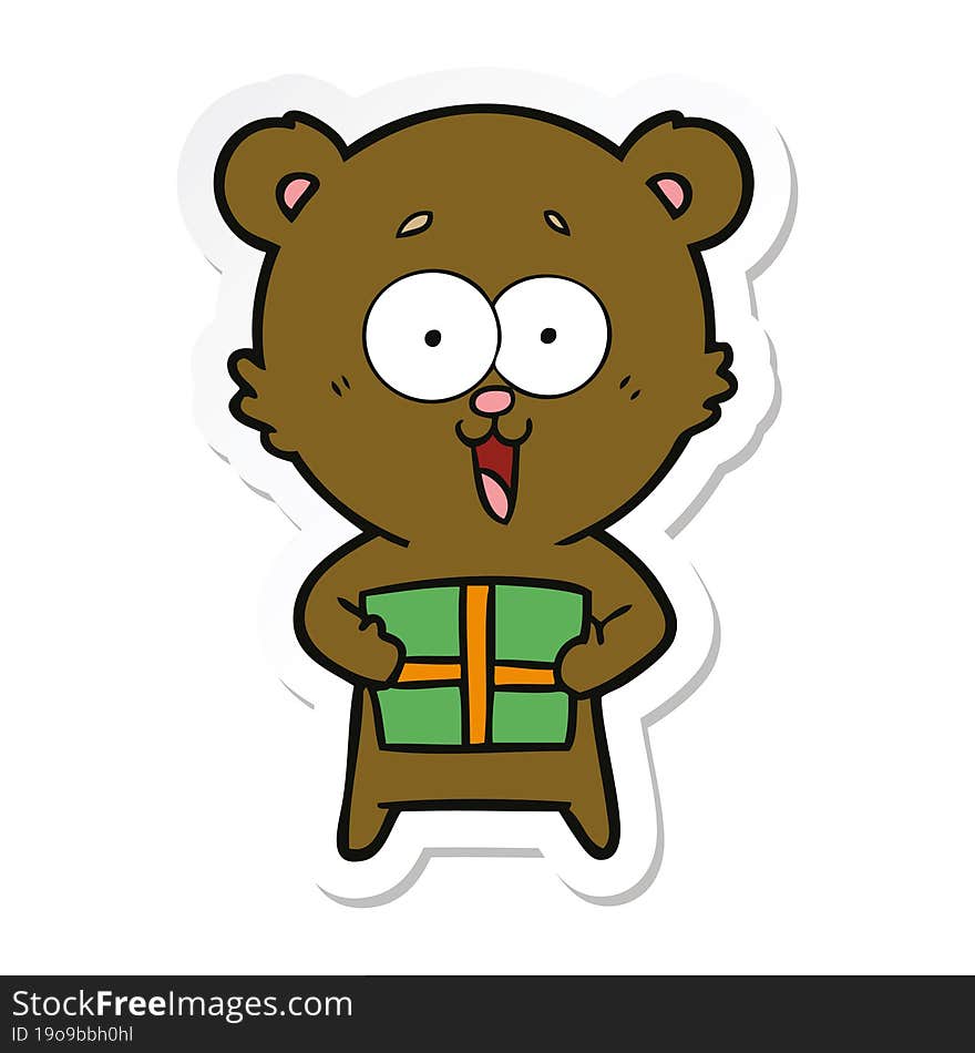 sticker of a laughing teddy  bear with christmas present