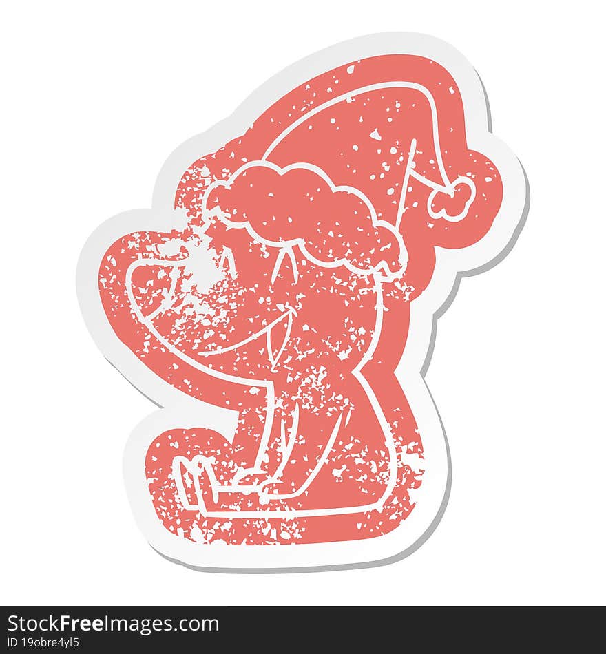 sitting bear cartoon distressed sticker of a wearing santa hat