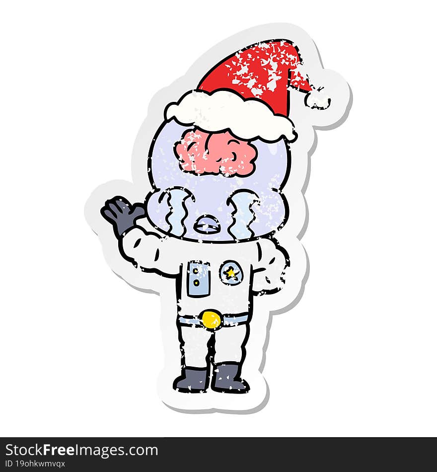 hand drawn distressed sticker cartoon of a big brain alien crying wearing santa hat