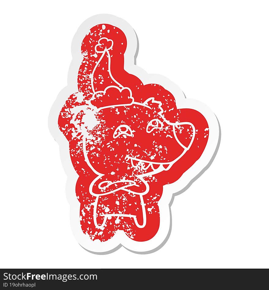 cartoon distressed sticker of a bear showing teeth wearing santa hat