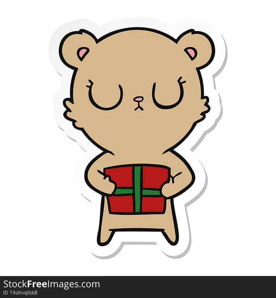 sticker of a peaceful cartoon bear with present