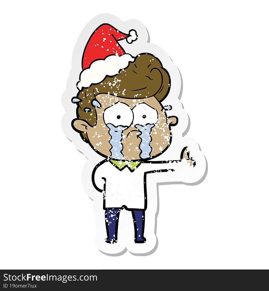 distressed sticker cartoon of a crying man wearing santa hat