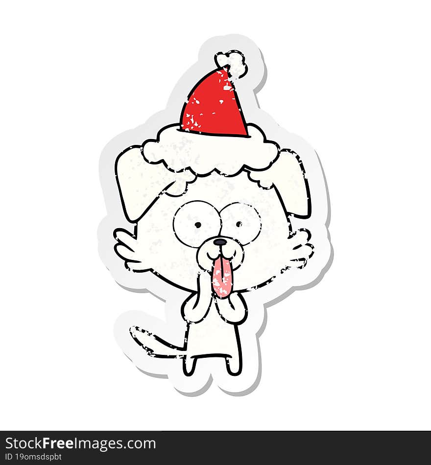 hand drawn distressed sticker cartoon of a dog with tongue sticking out wearing santa hat