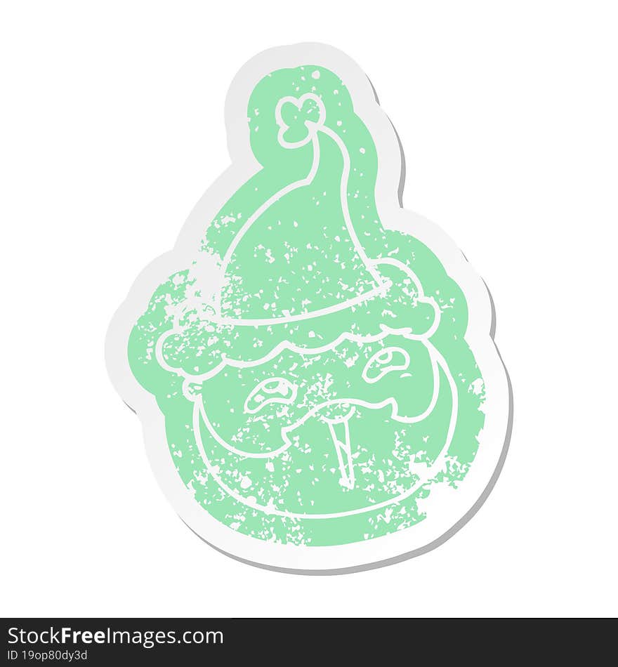 cartoon distressed sticker of a male face with beard wearing santa hat