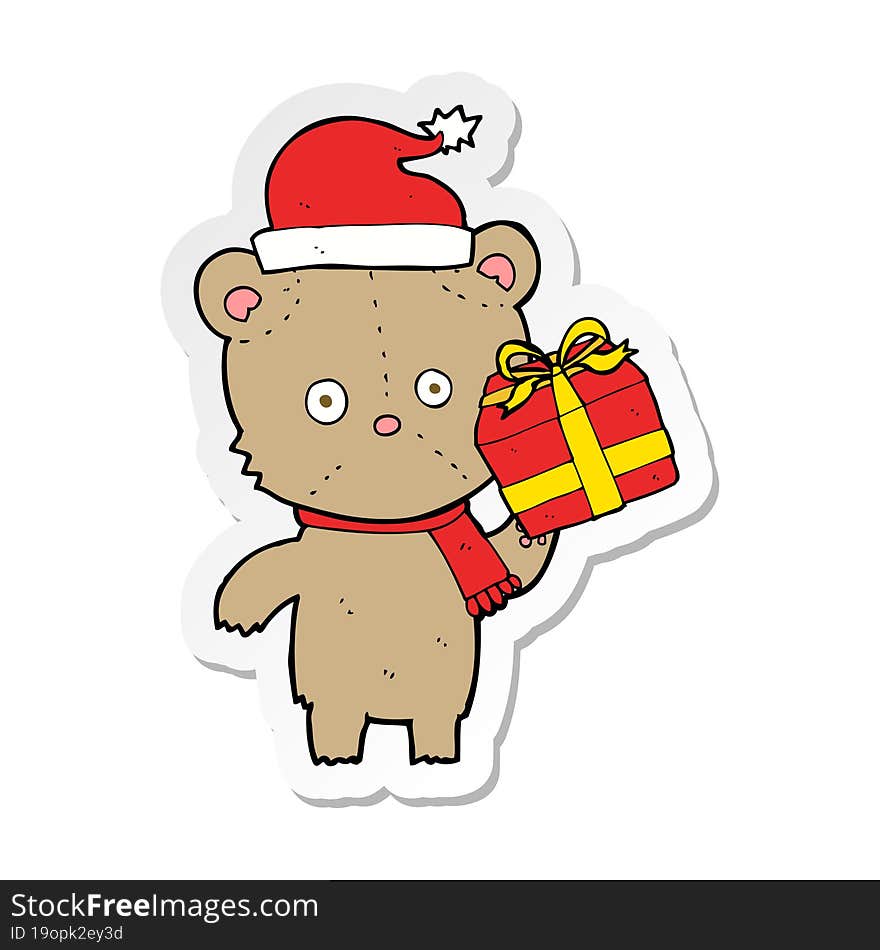 sticker of a cartoon christmas teddy bear with present