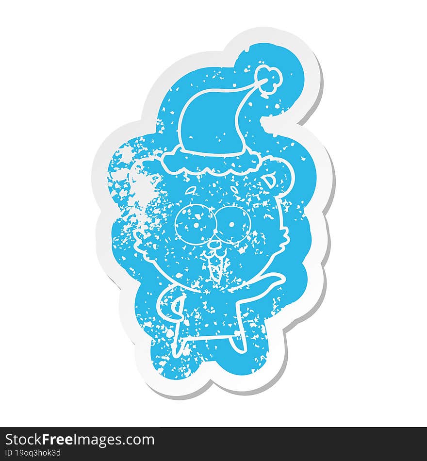 laughing teddy  bear cartoon distressed sticker of a wearing santa hat